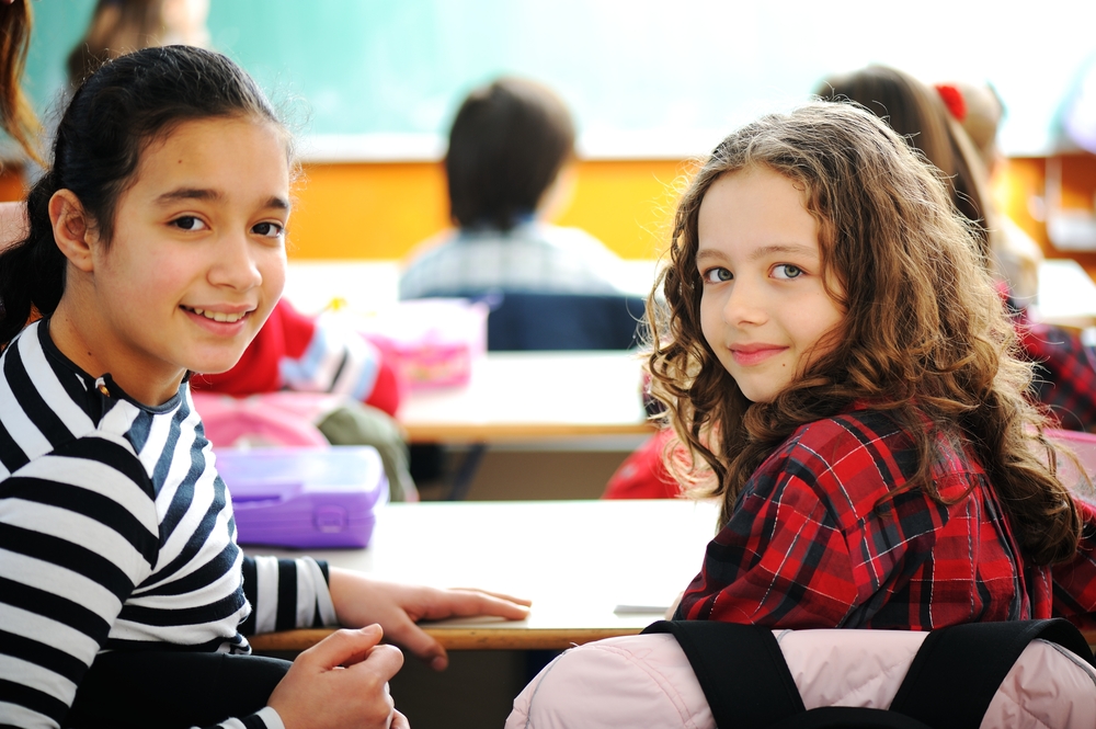 Cute lovely school children at classroom having education activities