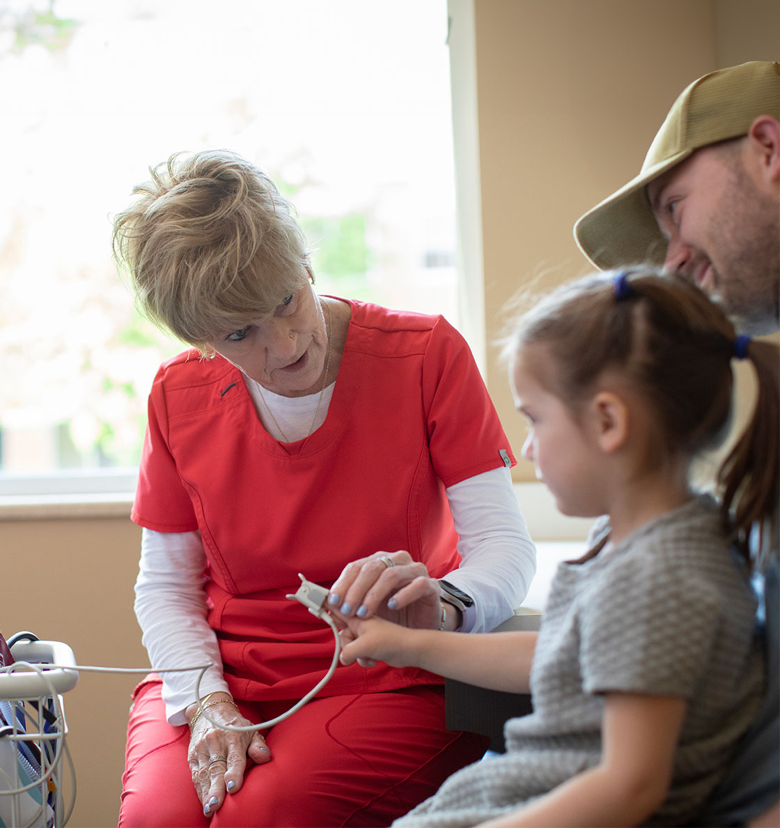 A clinician comforting a child through a test