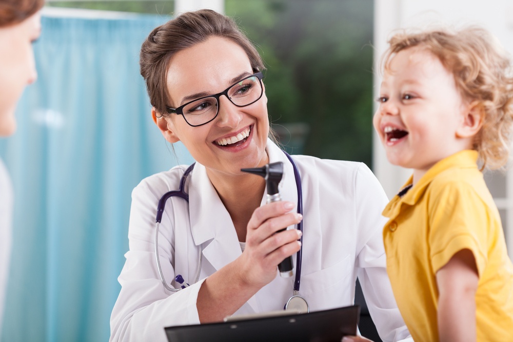 Happy child after a health exam at the doctor\'s office.