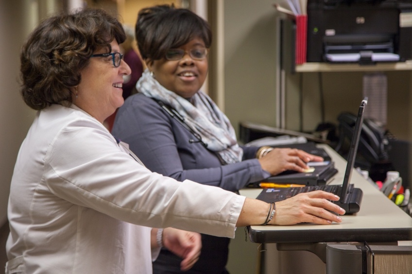 Doctor and assistant smiling at Robbinsdale clinic.